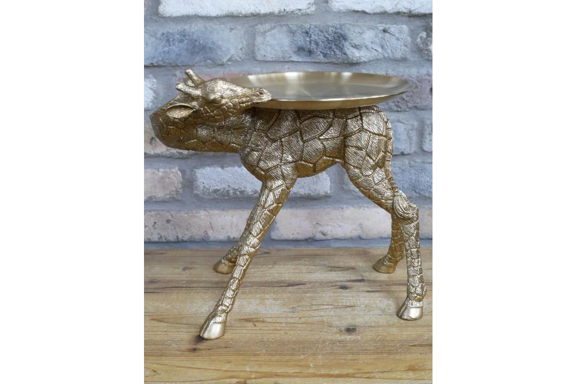 Gold giraffe side table with textured finish and round tray top on wooden floor
