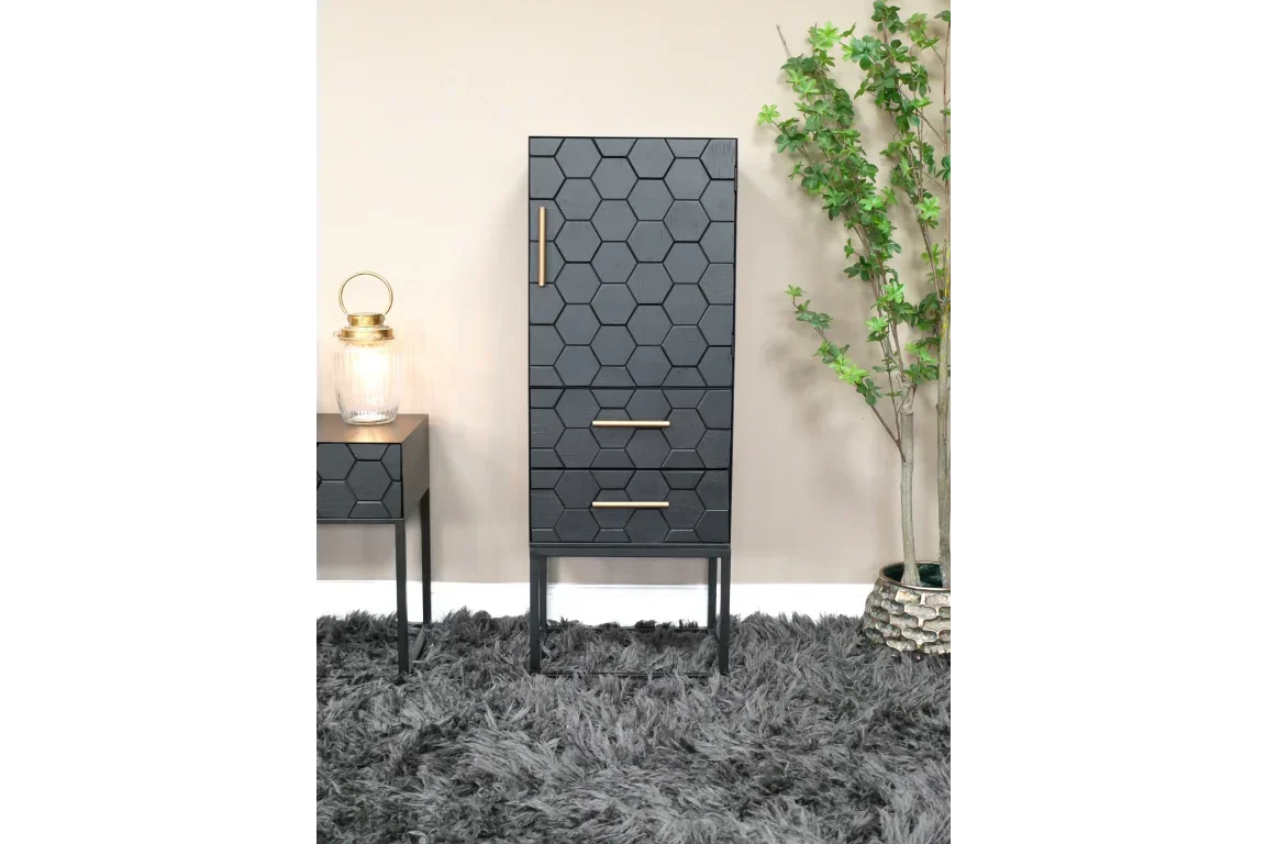Black hexagon pattern cabinet with gold handles on grey rug beside matching side table