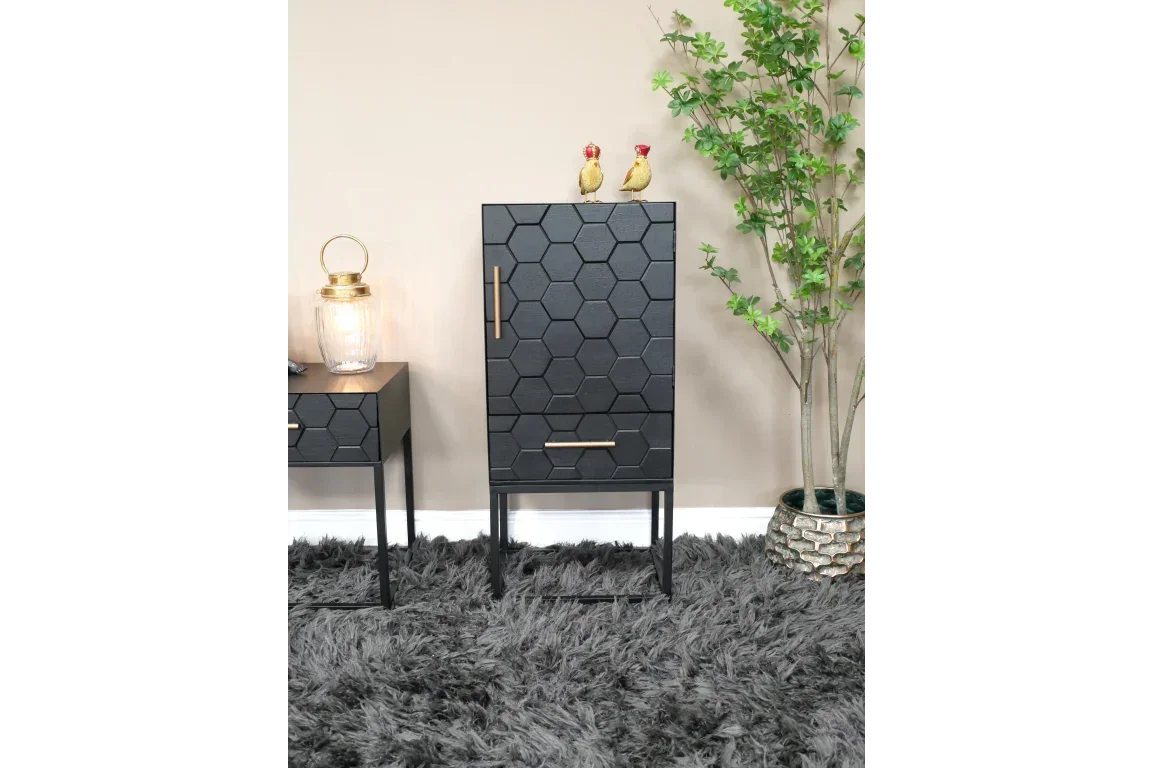 Black hexagon pattern cabinet with gold handles in modern living room setting