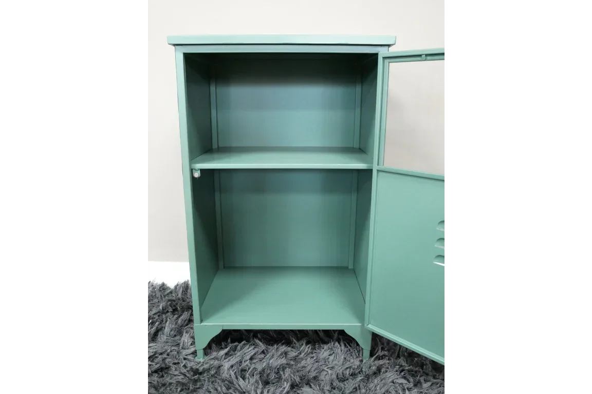 Green metal storage cabinet with one shelf and open door on grey textured rug