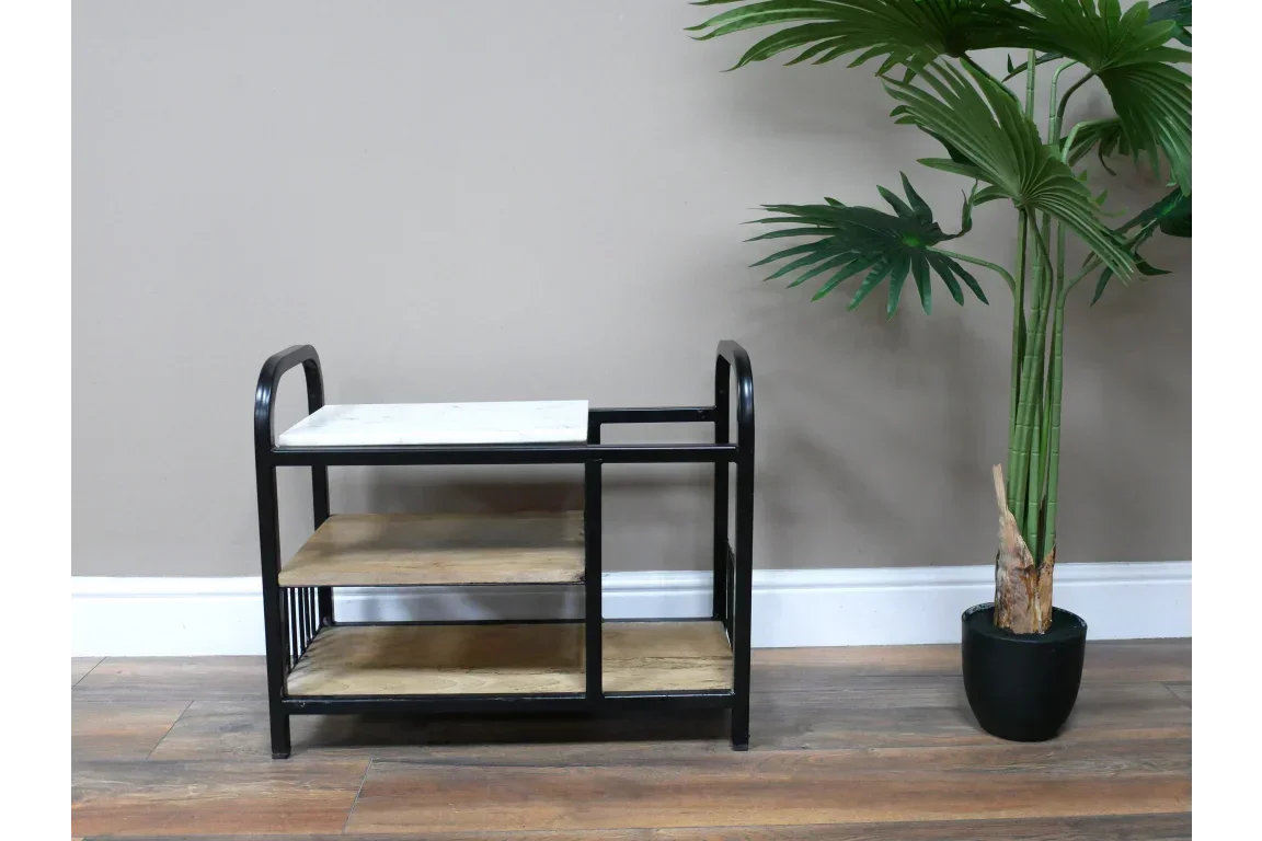 Black metal and wood console table with marble top, set beside a potted artificial palm plant