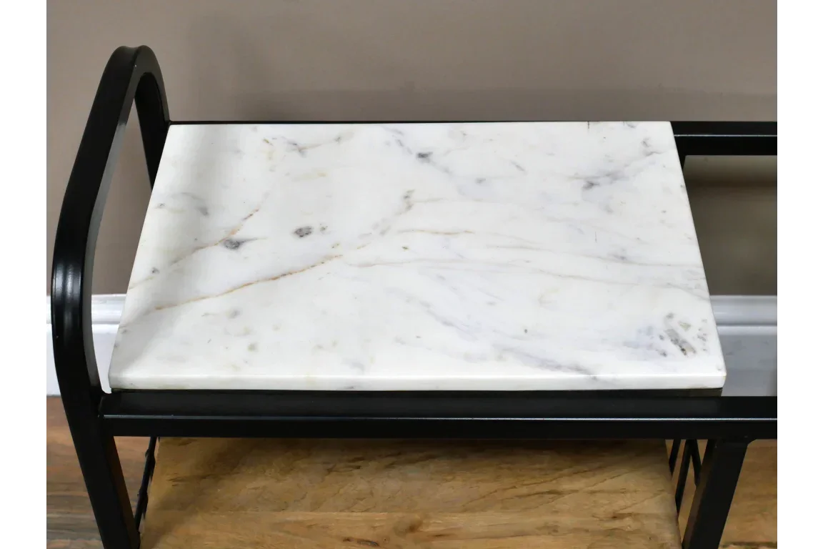 White marble console table top with black metal frame and curved arm detail