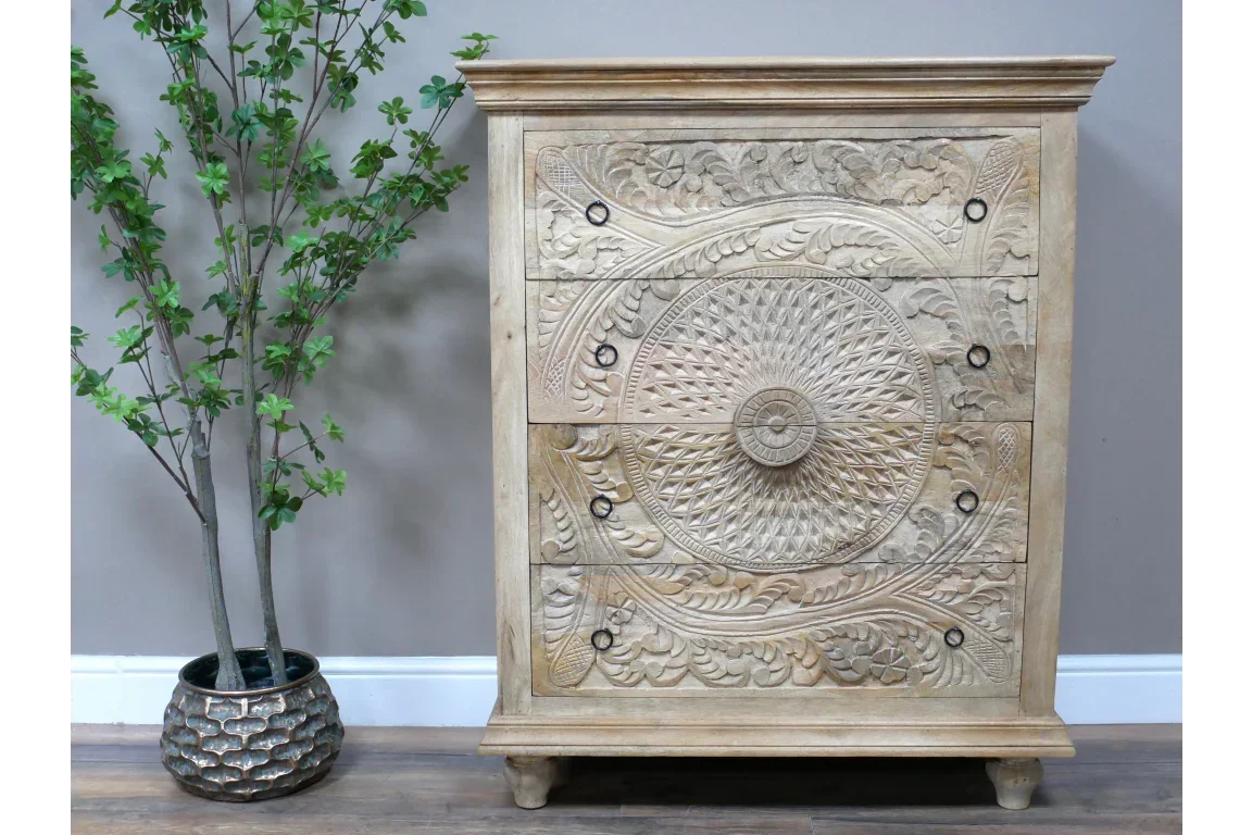 Carved wooden chest of drawers with intricate mandala pattern and metal drawer pulls