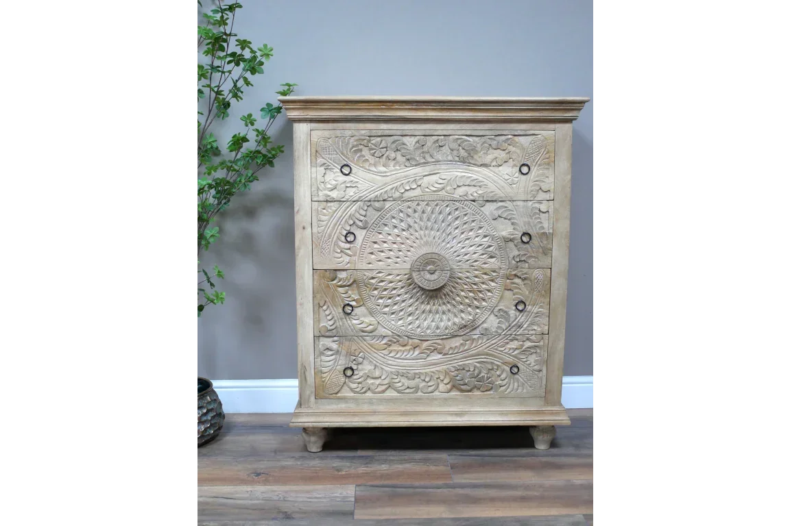 Carved wooden chest of drawers with floral and geometric patterns, natural finish