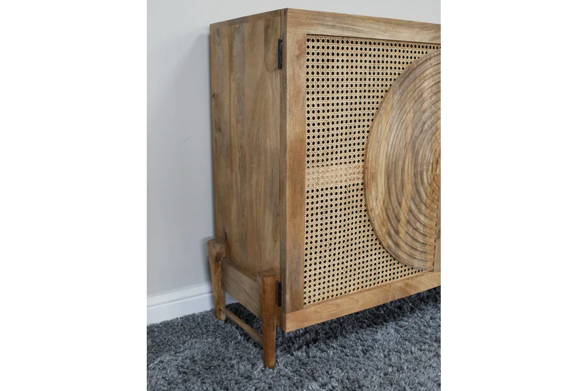 mango wood sideboard with woven rattan panel and carved circular detail on front