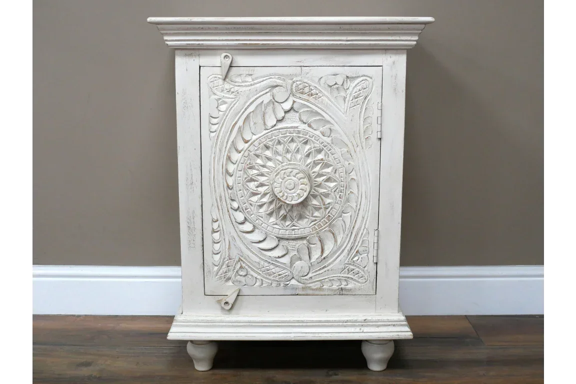 White carved wooden cabinet with ornate floral mandala design on front panel