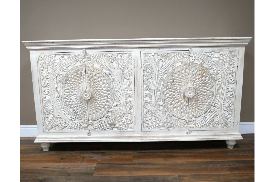 White carved wood sideboard with ornate floral and geometric front panel design