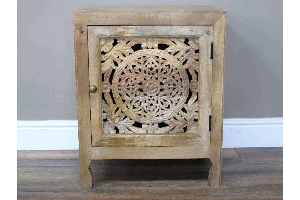 Carved wood bedside cabinet with floral mandala design on door, brass knob, natural finish