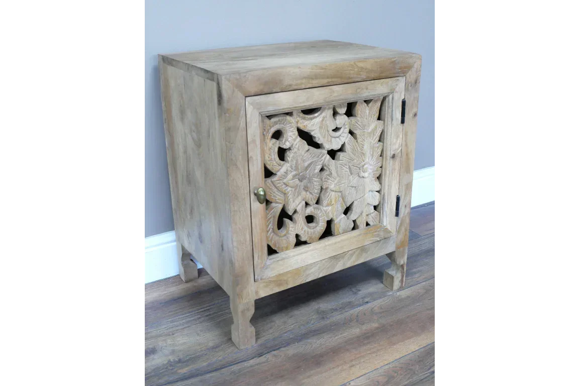 Natural wood cabinet with floral carved door on wooden floor