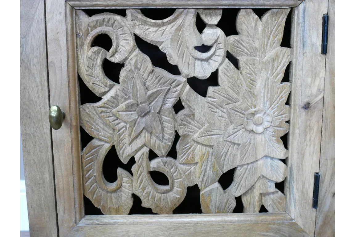 Wood cabinet door with intricate floral carved panel and brass knob detail