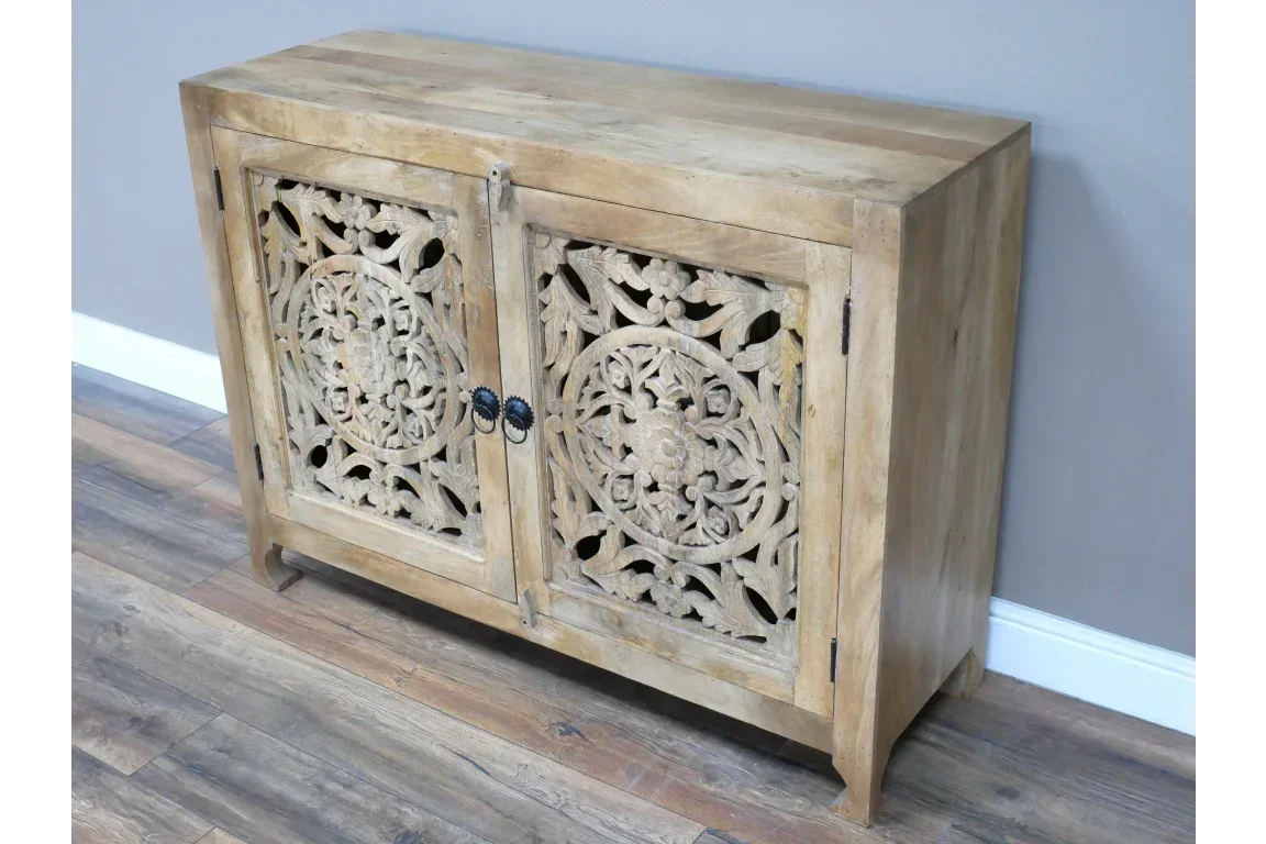 Light wood sideboard with ornate carved floral doors on wooden floor