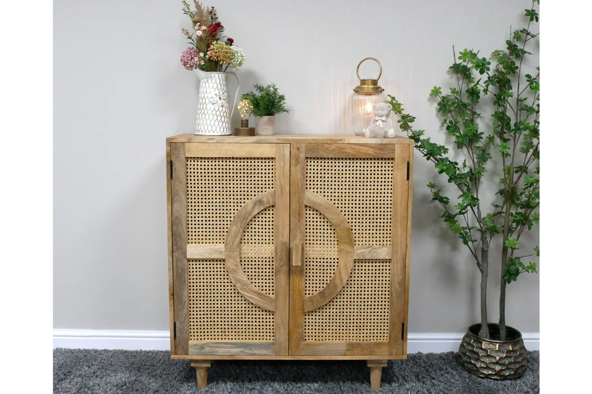 Wooden rattan sideboard with circle detail, styled with vases and plants in modern living room
