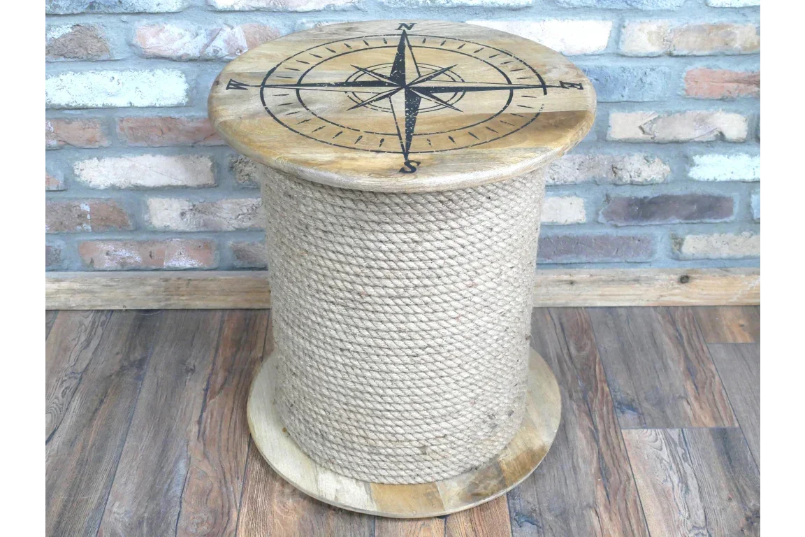 Rope wrapped wooden side table with compass design top on rustic wood floor