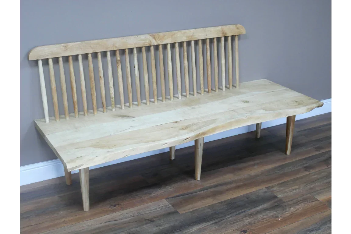 Solid wood bench with spindle backrest and natural edge seat on laminate floor