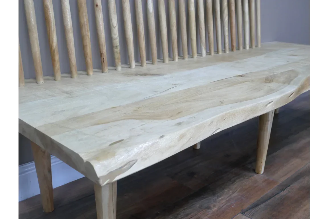 Solid wood bench with spindle backrest and natural grain, angled view on wood floor