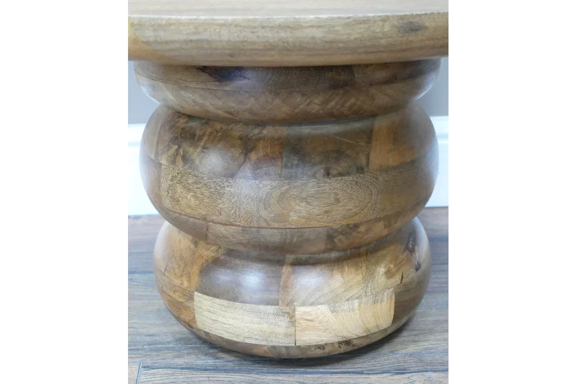 Round wooden coffee table base with natural wood grain finish on hardwood floor