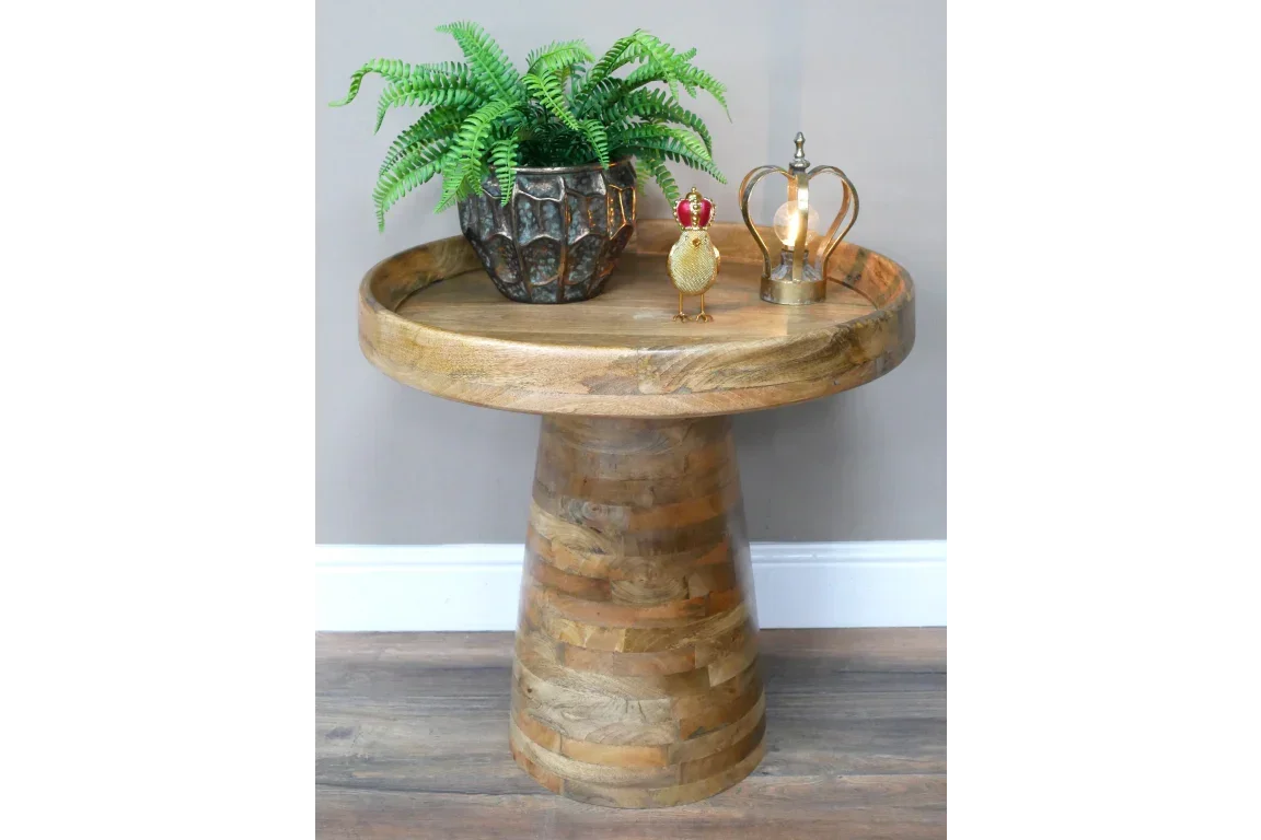 Round mango wood side table with plant, decorative bird, and gold lamp on top
