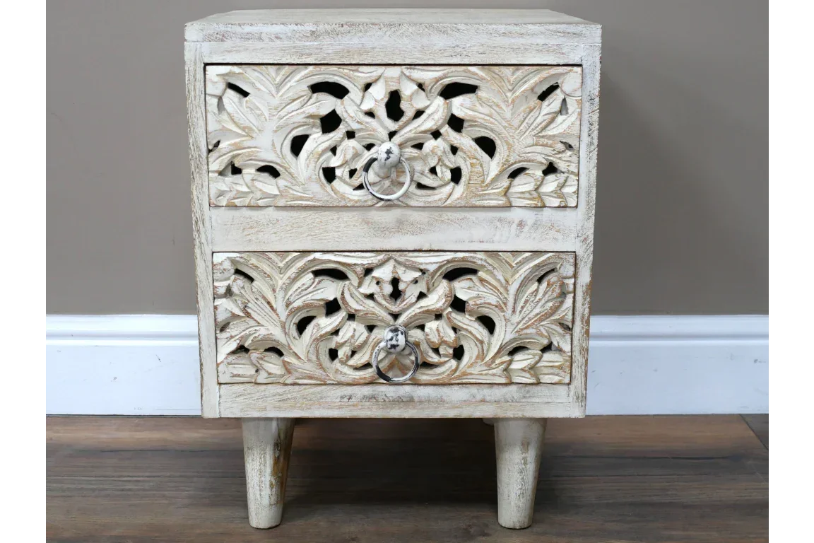 Carved wood bedside table with two drawers and ring handles, whitewashed finish on legs