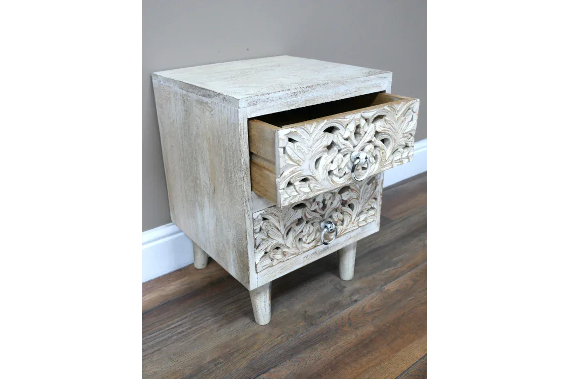 Carved wood bedside table with distressed finish and two drawers, top drawer open