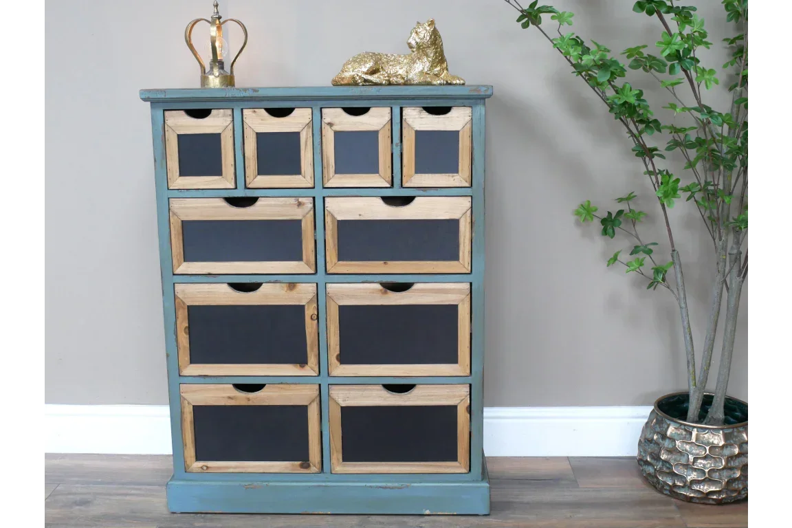 Rustic wooden chest of drawers with blue frame and black panels, set against a neutral wall
