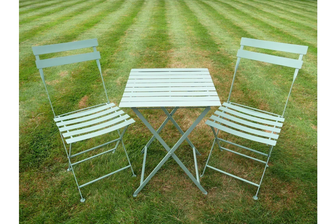 Metal bistro garden set with two chairs and square table on striped lawn