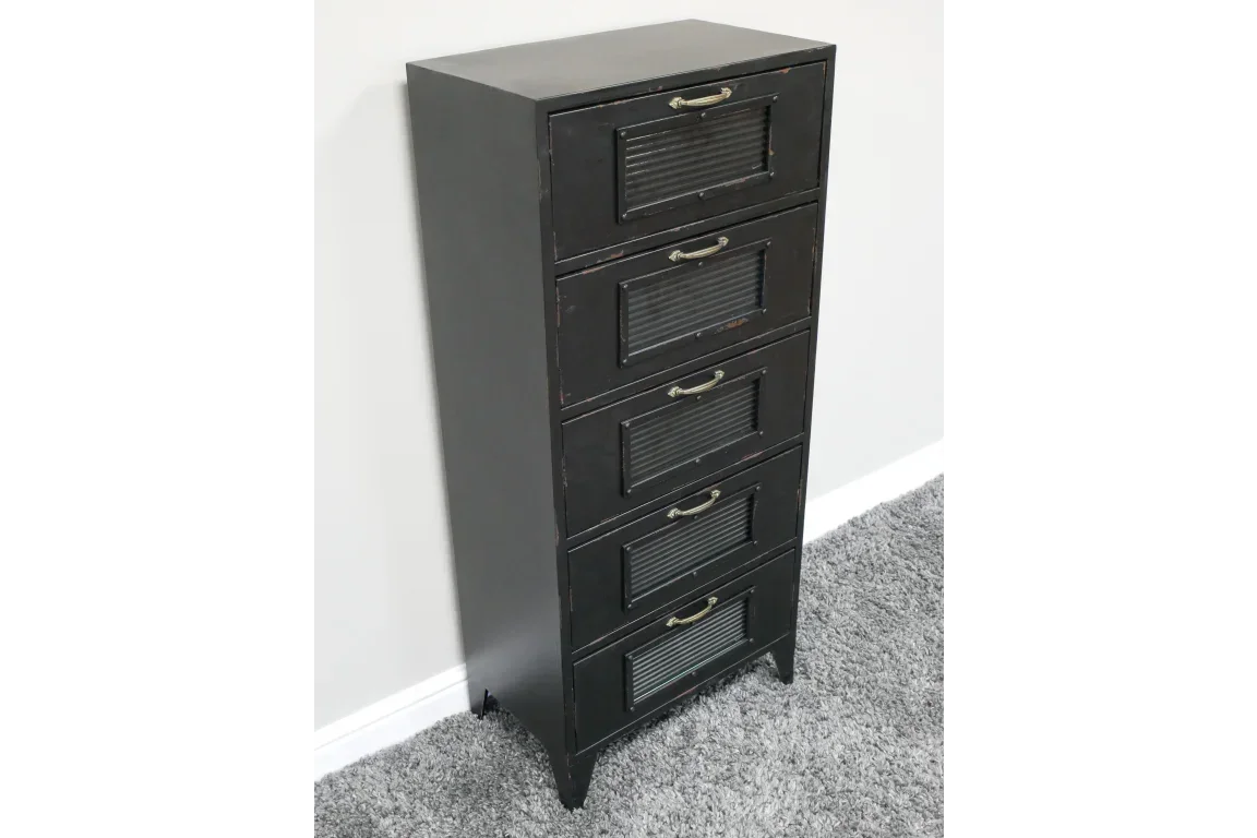 Black tall chest of drawers with five metal handles and ribbed drawer fronts on carpet