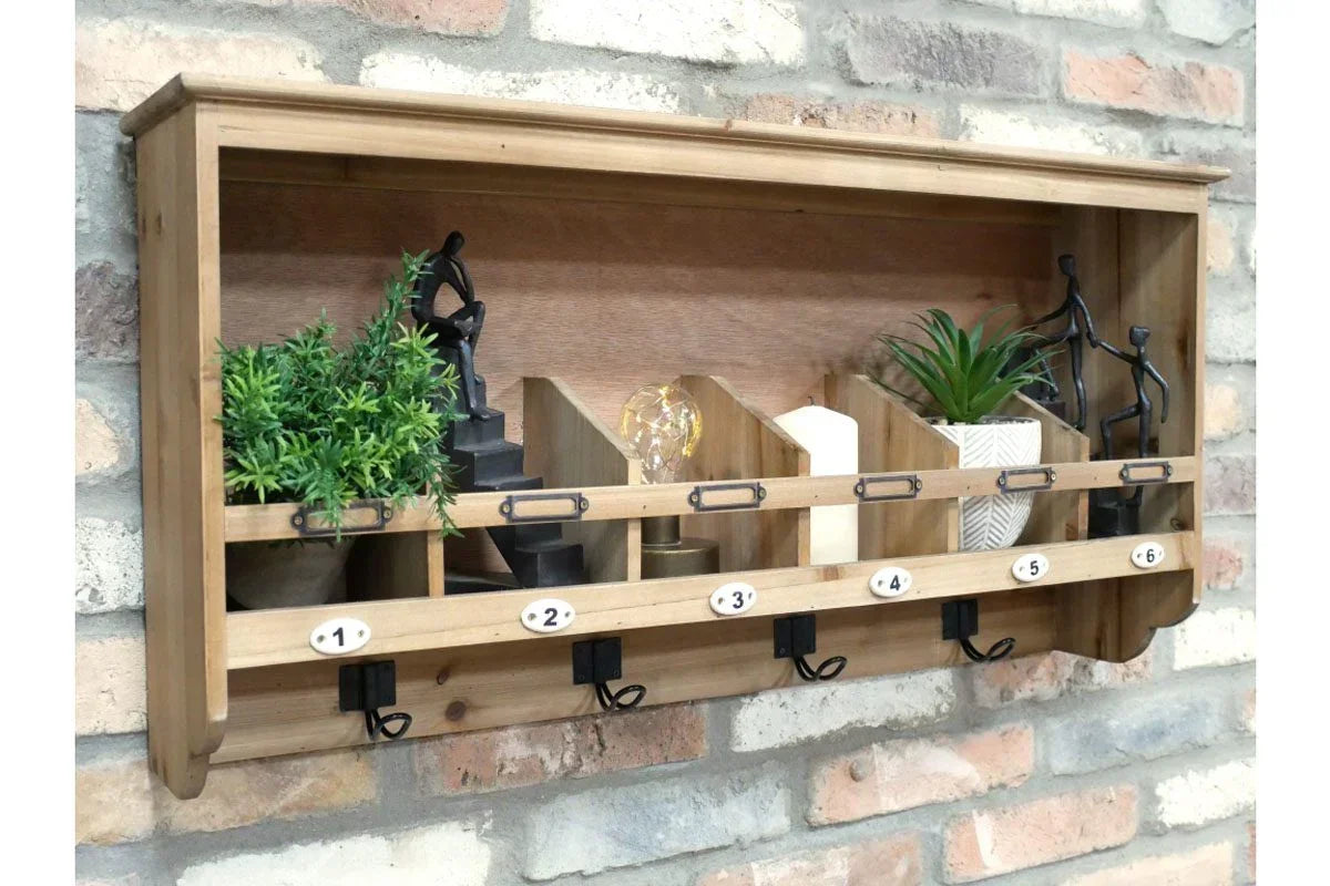 Wall mounted wooden key rack with six hooks, cubbies, plants, and decorative figures