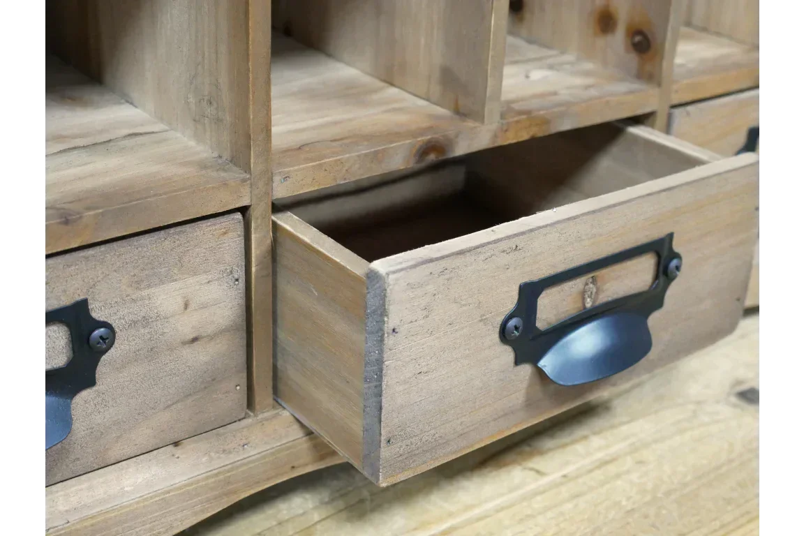Rustic wooden storage cabinet with metal handle, close-up of open drawer