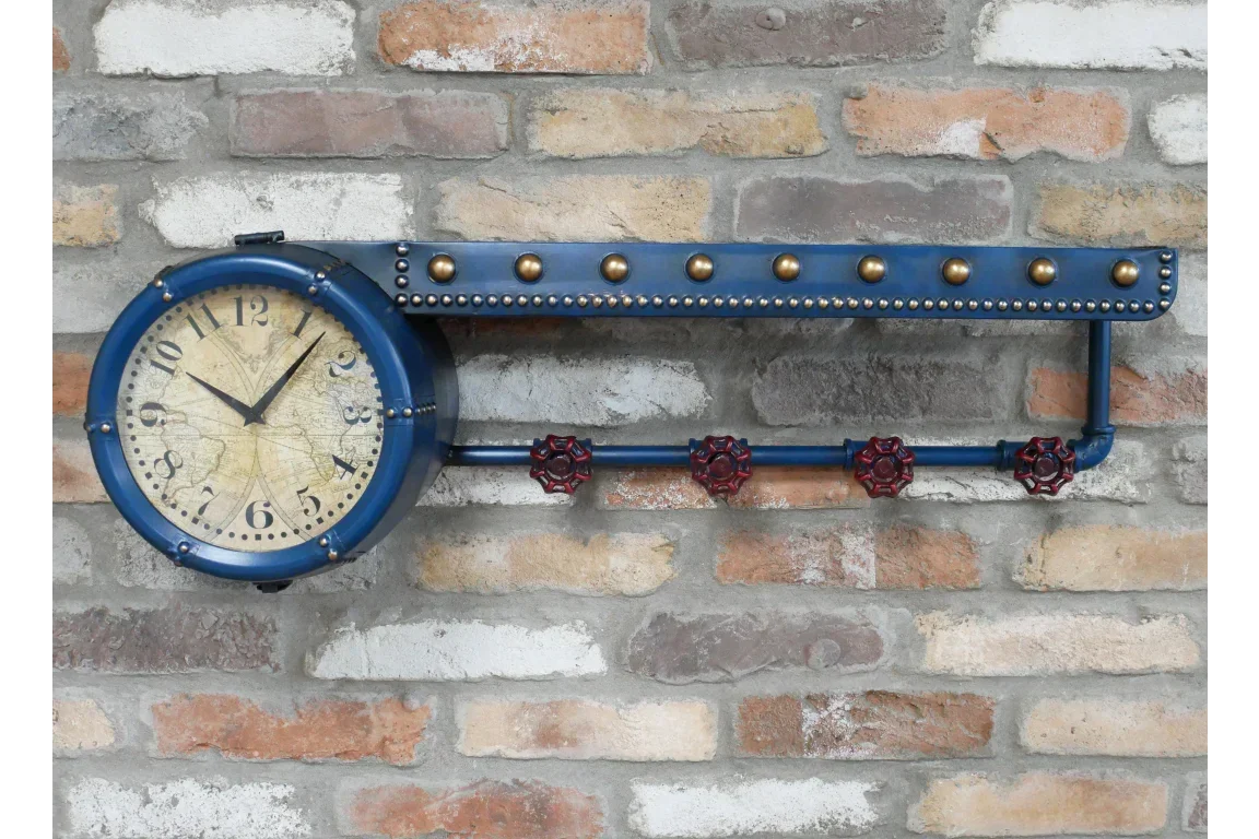 Industrial wall clock with blue metal frame and red valve accents on exposed brick wall