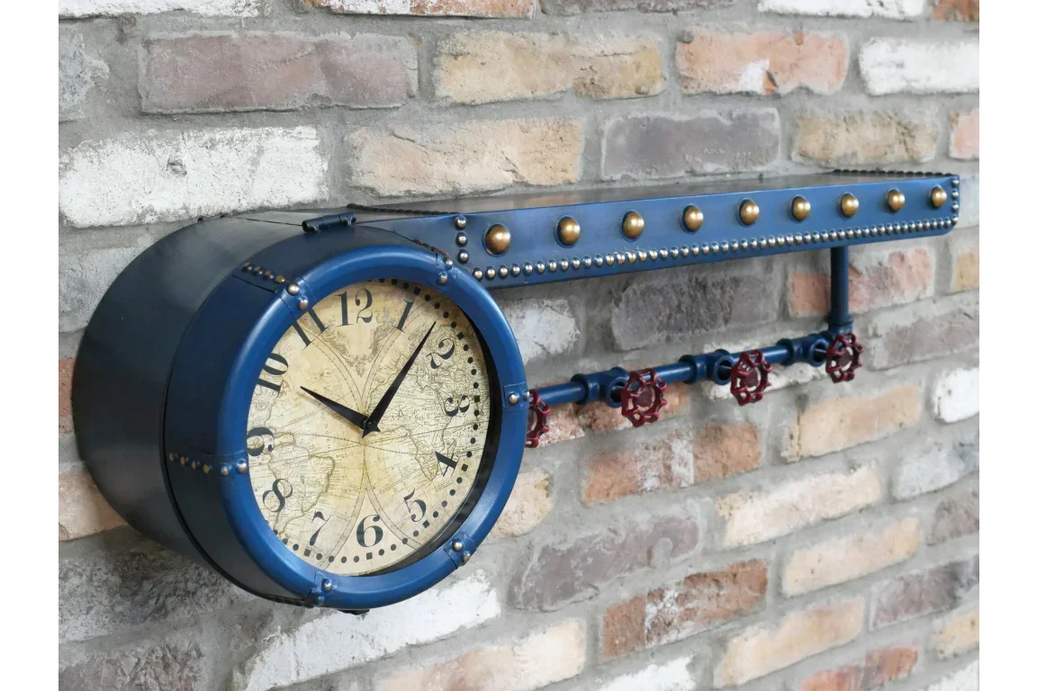 Industrial wall clock with blue metal casing and gold rivets mounted on brick wall