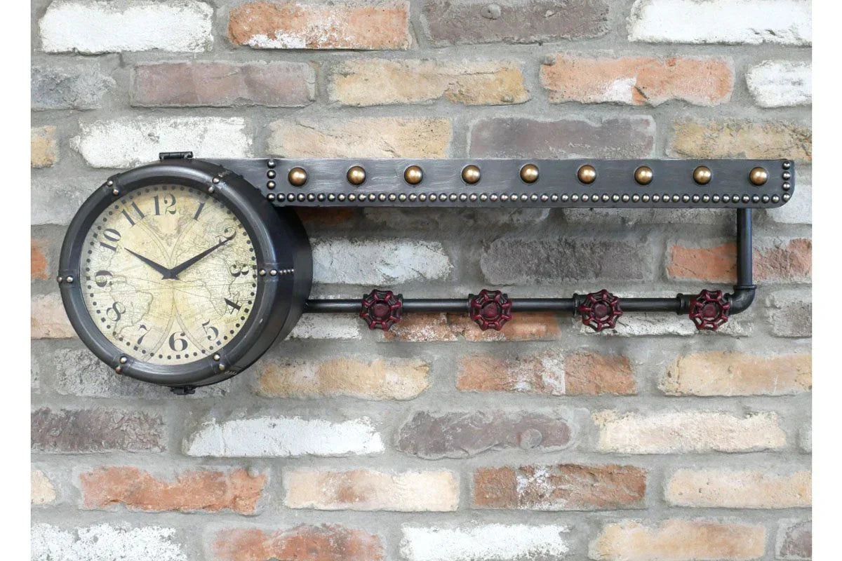 Industrial wall clock with black metal frame and vintage dial on exposed brick background
