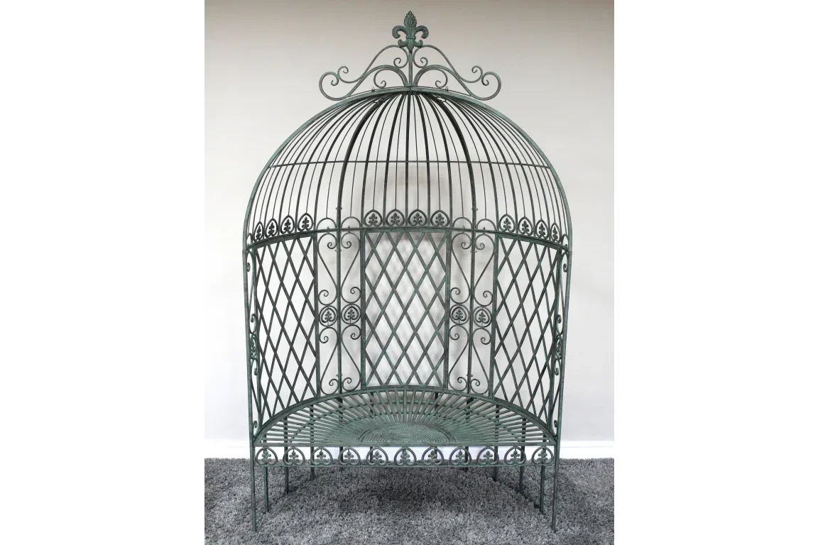 Green metal garden bench with ornate dome backrest and lattice design