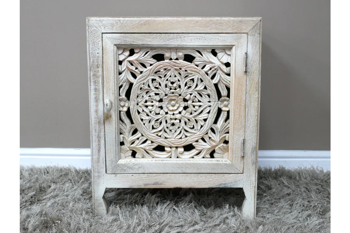 Carved wooden bedside cabinet with intricate floral panel and light wood finish