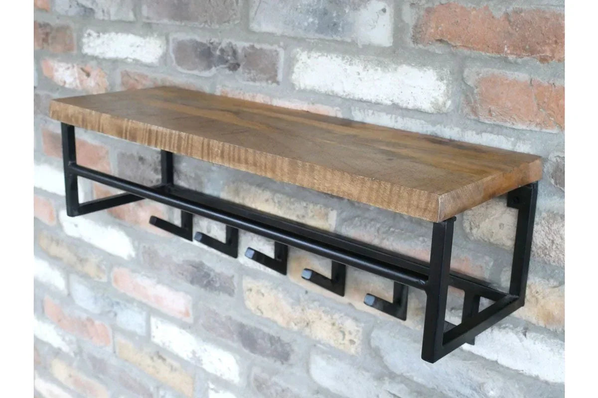 Industrial wall shelf with solid wood top and black metal hooks mounted on brick wall