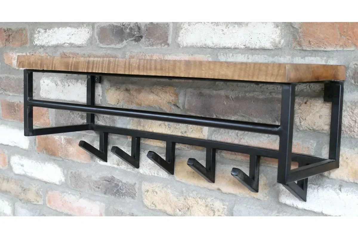 Industrial wall mounted coat rack with black metal frame and wooden shelf on brick wall