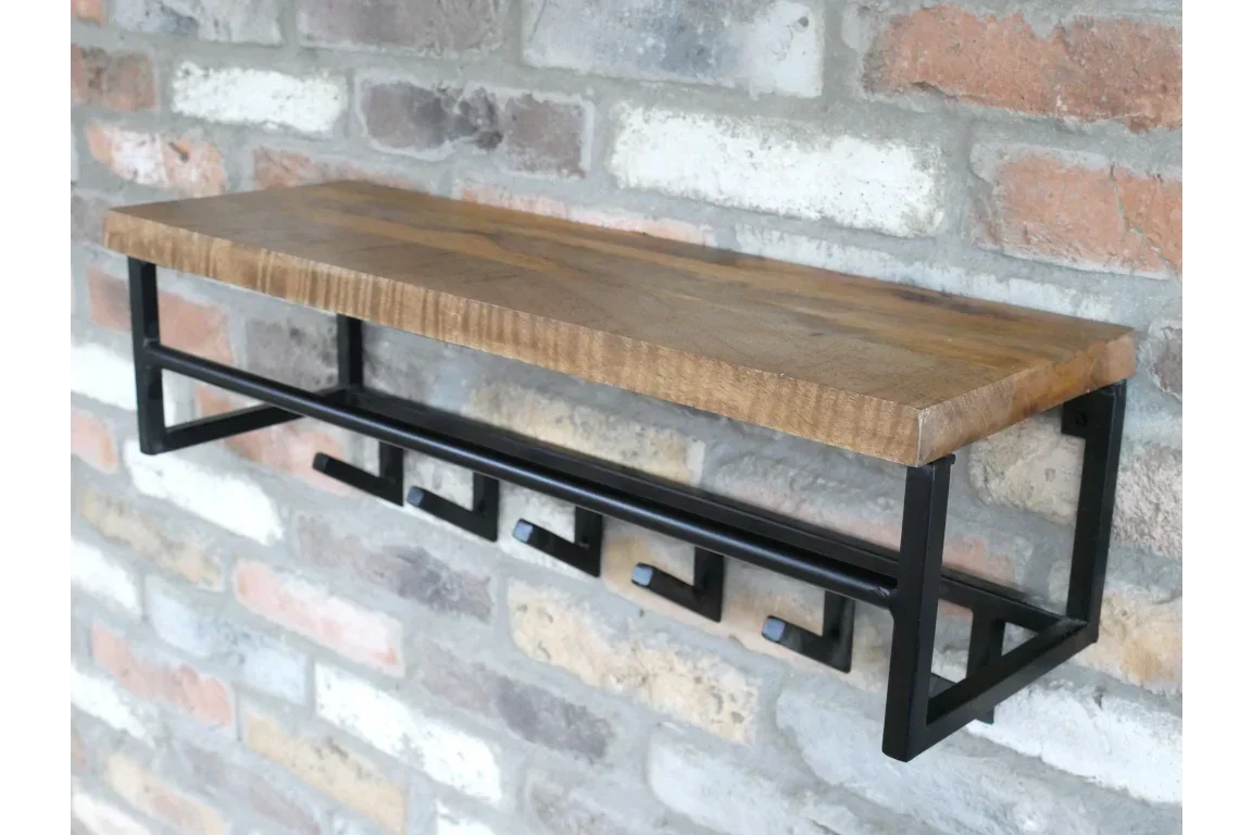 Industrial wood and metal wall shelf with hooks mounted on brick wall