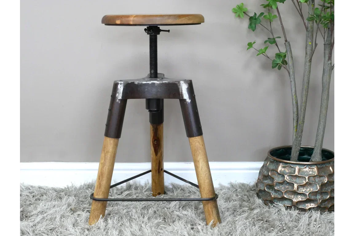 Industrial wooden bar stool with metal frame and adjustable seat on grey rug