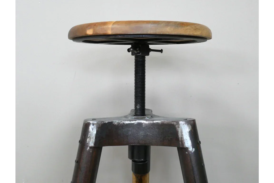 Industrial bar stool with round wooden seat and adjustable metal screw base