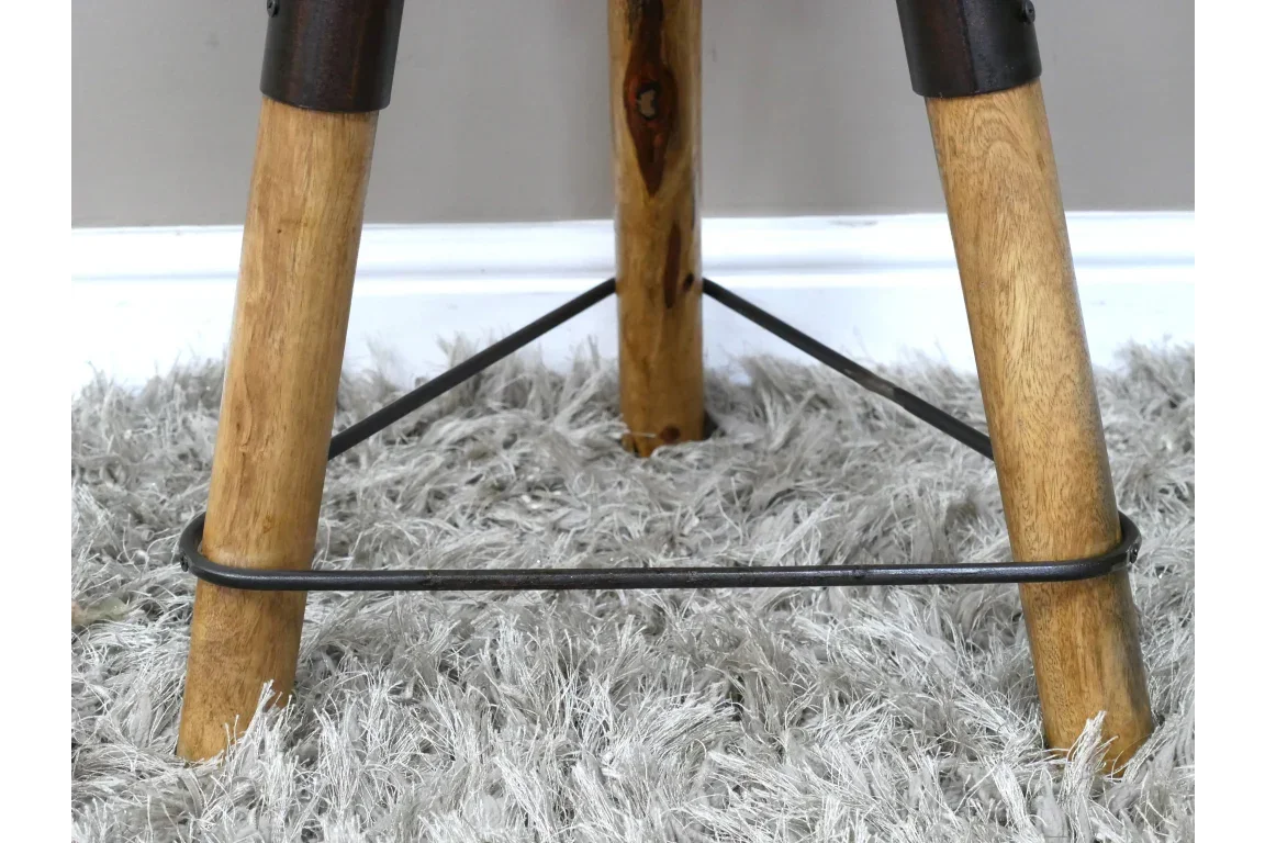 Wooden furniture legs with metal supports on grey shaggy rug