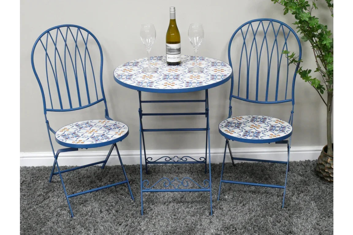 Blue metal bistro set with patterned table and chairs, wine bottle and glasses on tabletop