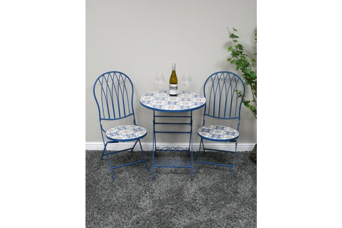 blue mosaic bistro table and two chairs set with wine bottle and glasses on grey carpet