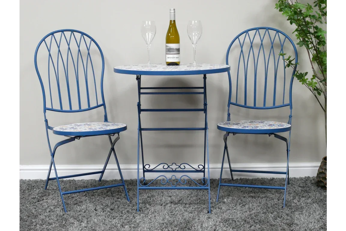 Blue metal bistro set with mosaic table, two chairs, wine bottle and glasses on tabletop