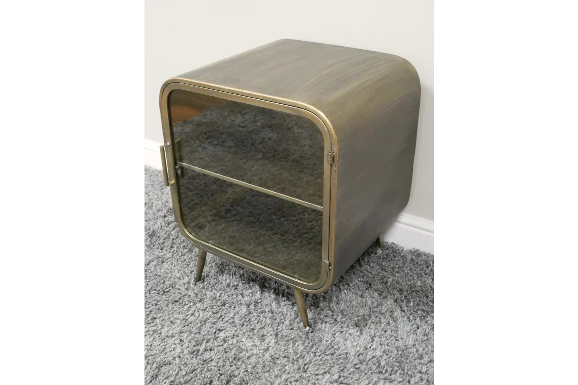 Brass metal side cabinet with glass door and shelf on grey carpet