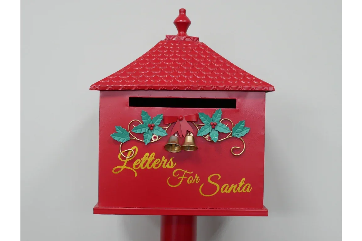 Red Christmas mailbox with gold bells, holly decorations, and Letters For Santa text on front