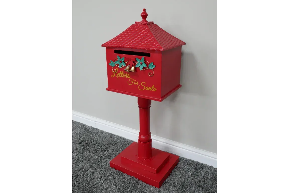 Red Christmas letters for Santa post box with gold script on a stand, decorated with holly