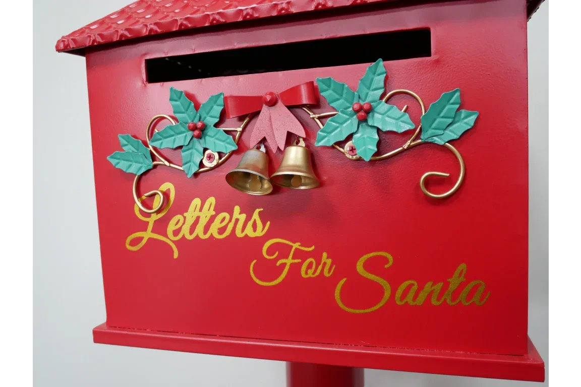 Red Christmas mailbox for Letters for Santa with holly leaves, gold bells, and festive bow