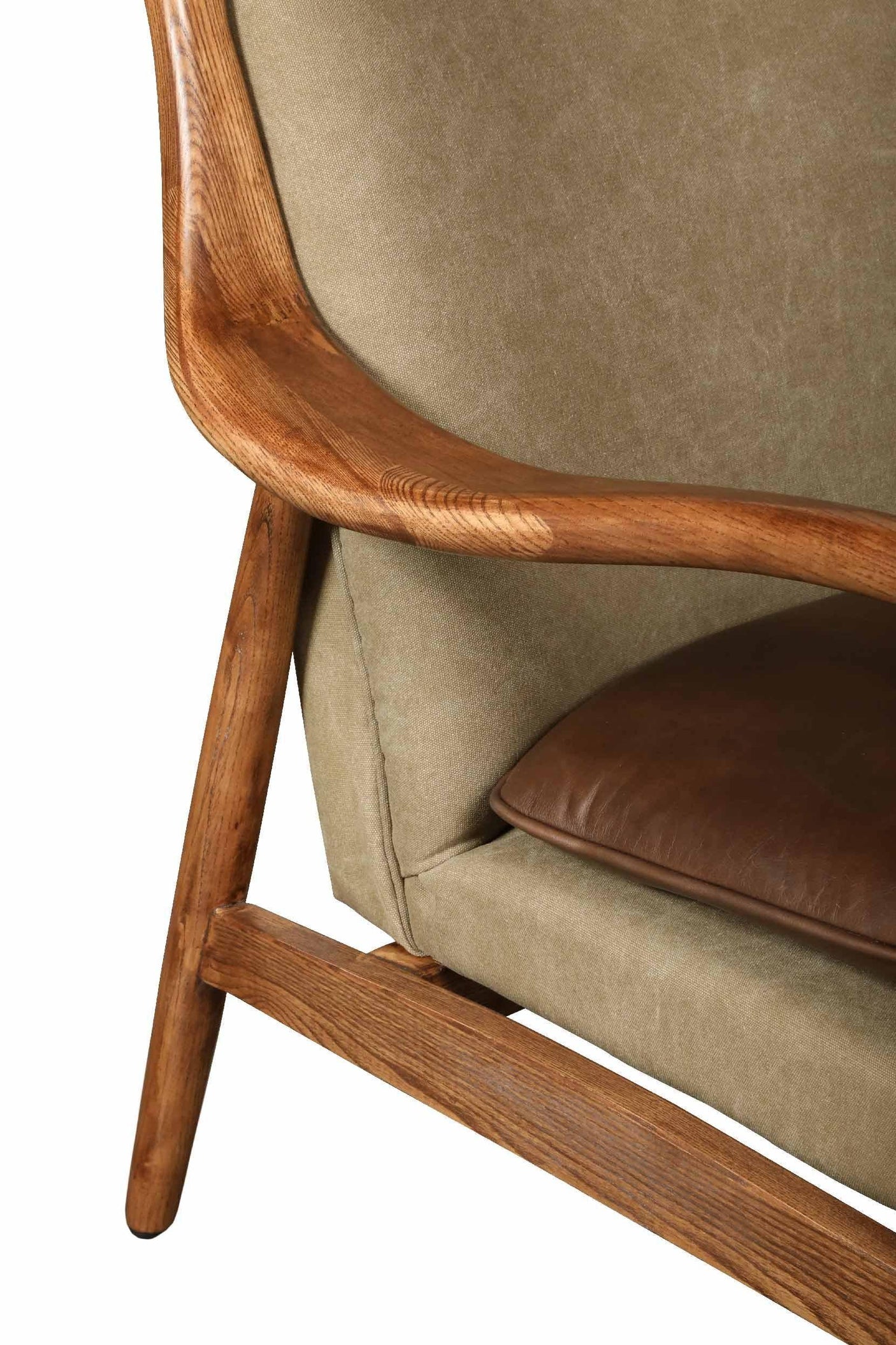 Close view of wooden armchair with light fabric upholstery and brown leather seat cushion