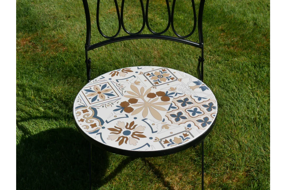 Outdoor mosaic garden chair with metal frame and decorative ceramic seat on grass
