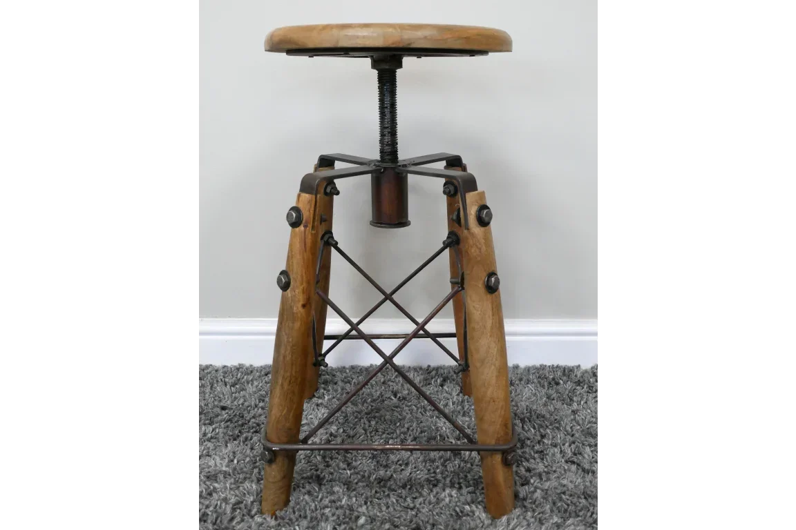 Industrial wooden bar stool with adjustable metal screw base on grey carpet