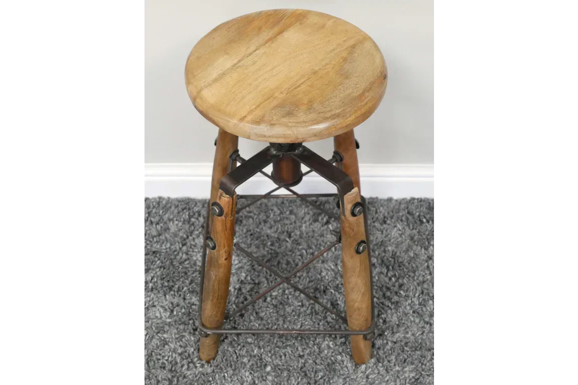 Round wooden bar stool with metal frame legs on grey carpet